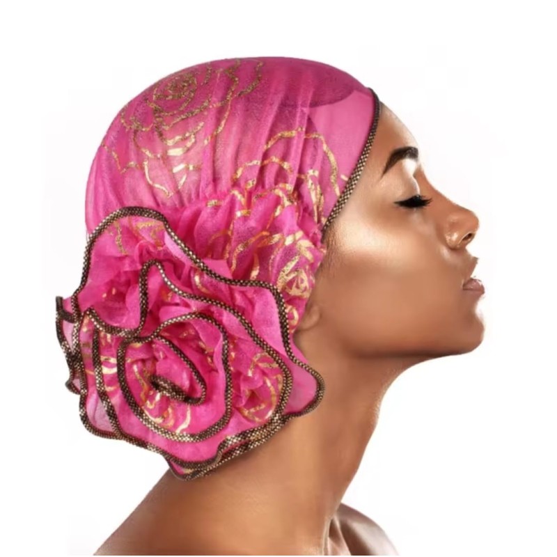 Turbante tela elásticada , color rosado o negro con flores doradas y una flor grande de adorno